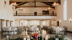 Banquet hall with valuted ceilings, exposed wood beams, and stately windows for natural lighting at Fillmore Chapel by Wedgewood Events