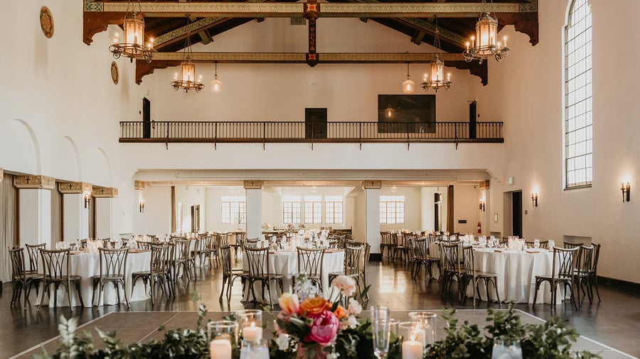 Banquet hall with valuted ceilings, exposed wood beams, and stately windows for natural lighting at Fillmore Chapel by Wedgewood Events