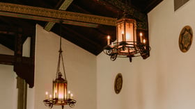 Vintage style wrought iron chandeliers and elaborate exposed wood beams at Fillmore Chapel by Wedgewood Events