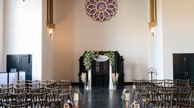 White wall indoor ceremony space with gorgeous stained glass and vintage stylings at Fillmore Chapel by Wedgewood Events